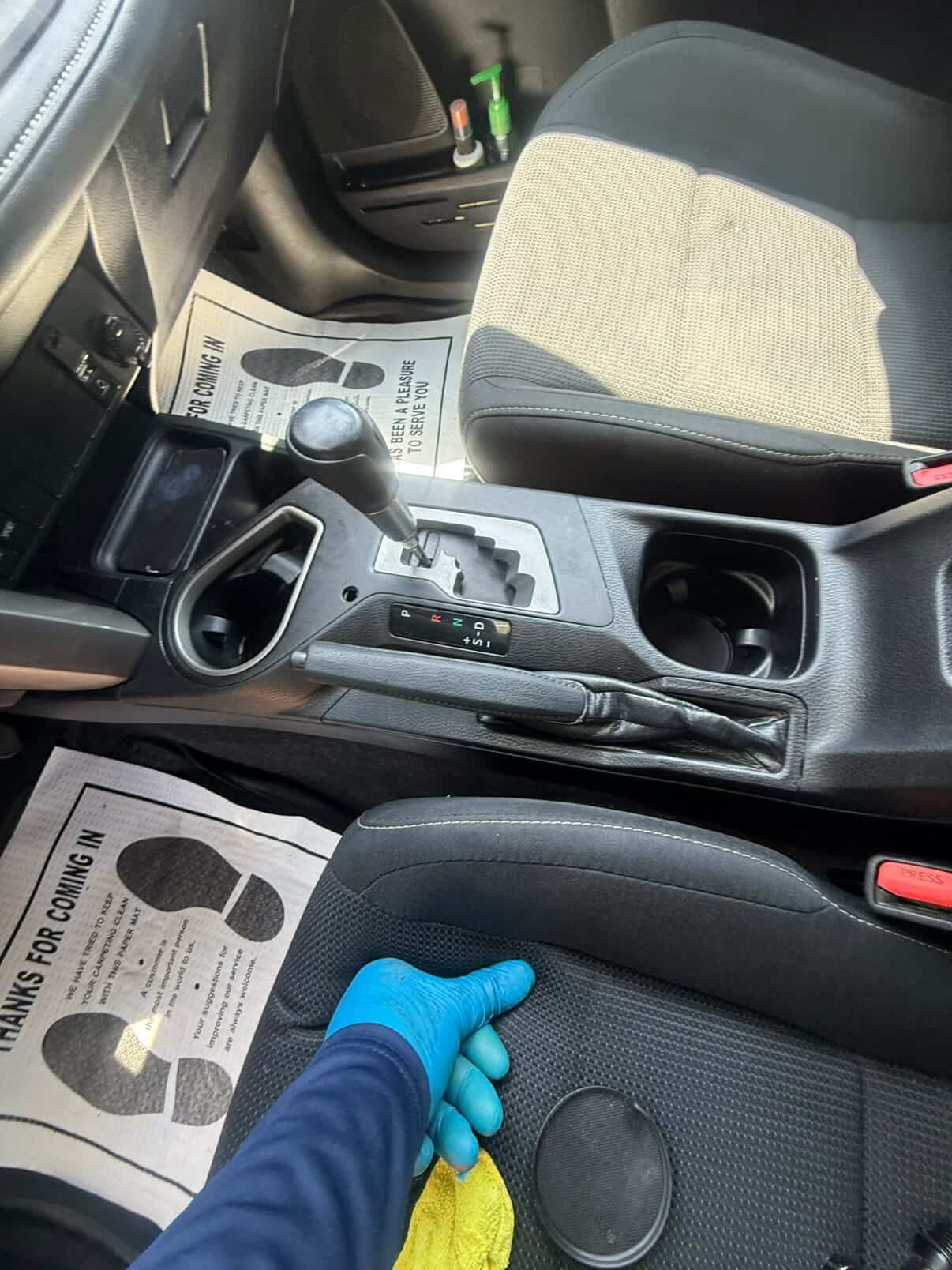 Detailer cleaning center console and shifter area