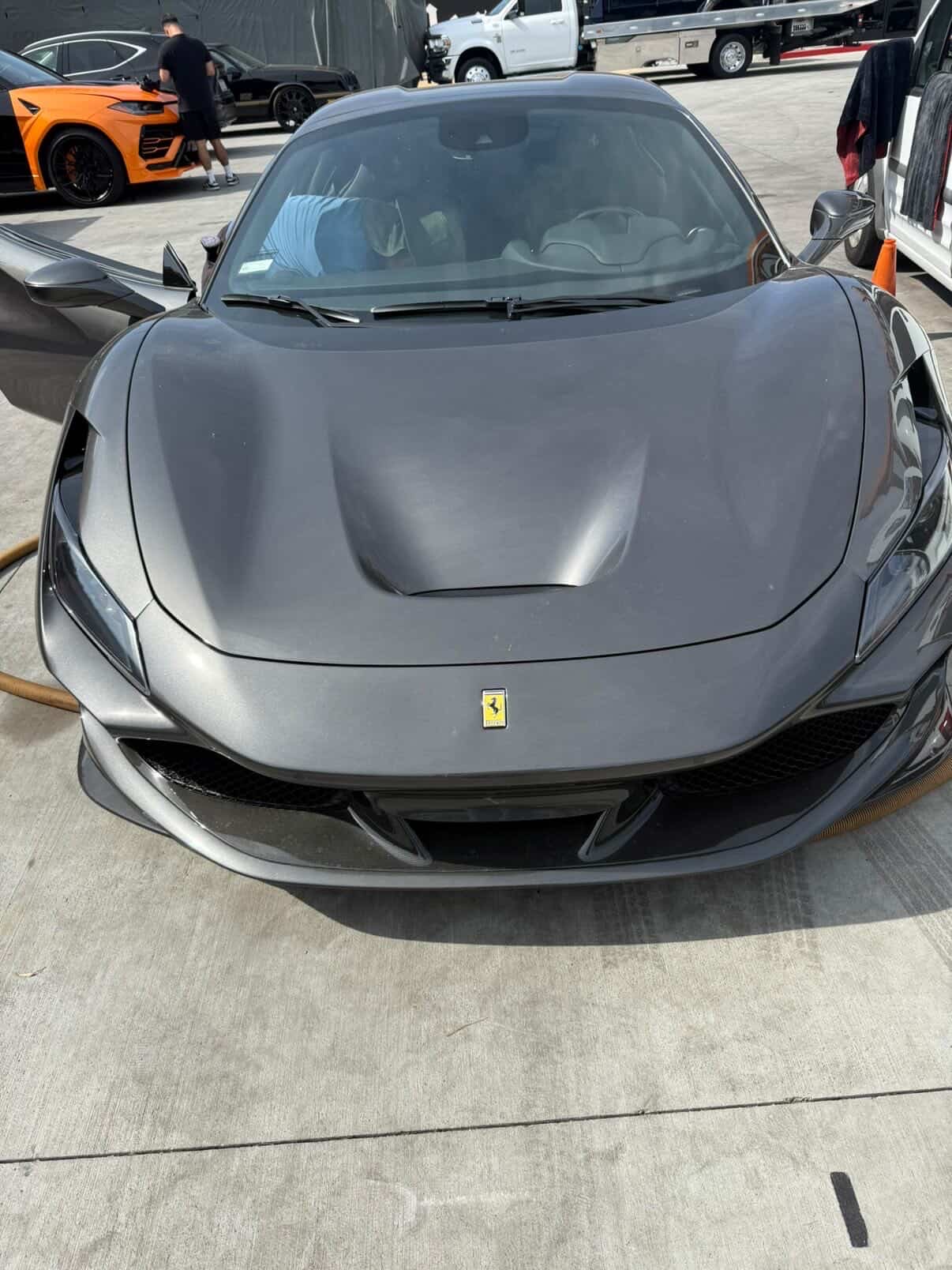 Gray Ferrari F8 supercar detailed at shop