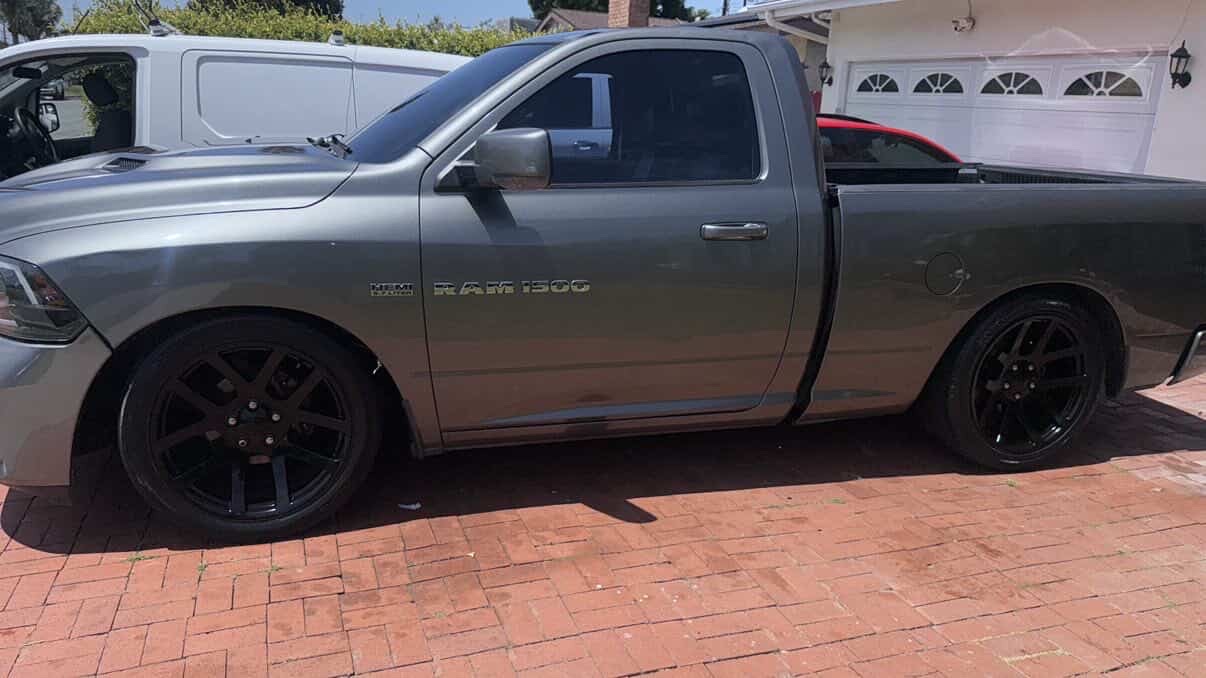 Lowered gray Dodge Ram 1500 with black wheels